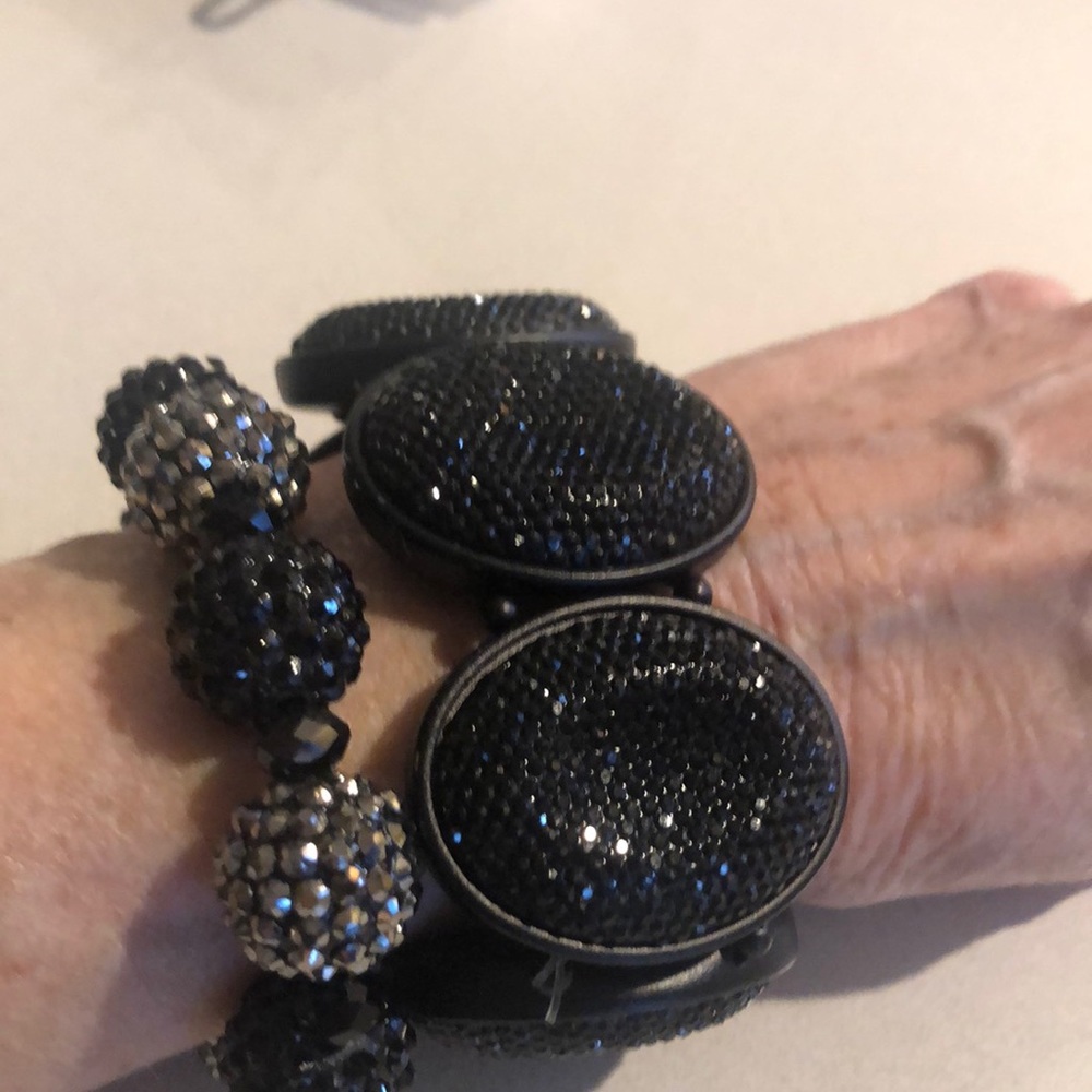 2 black and silver bracelets